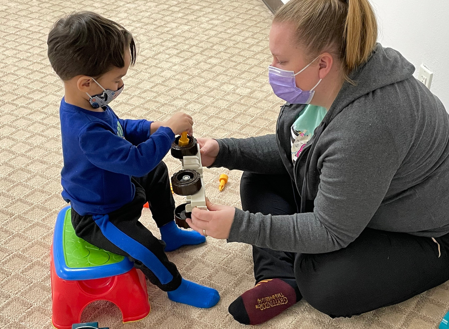 Image of a Child building a truck with the therapist